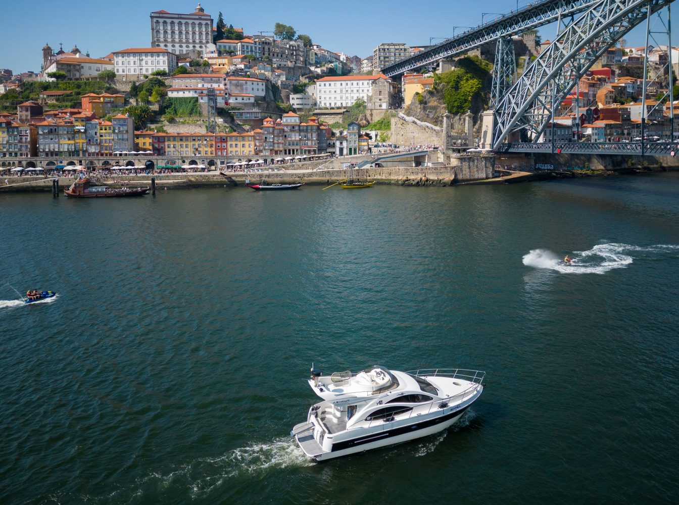 a boat traveling across a bridge over a body of water